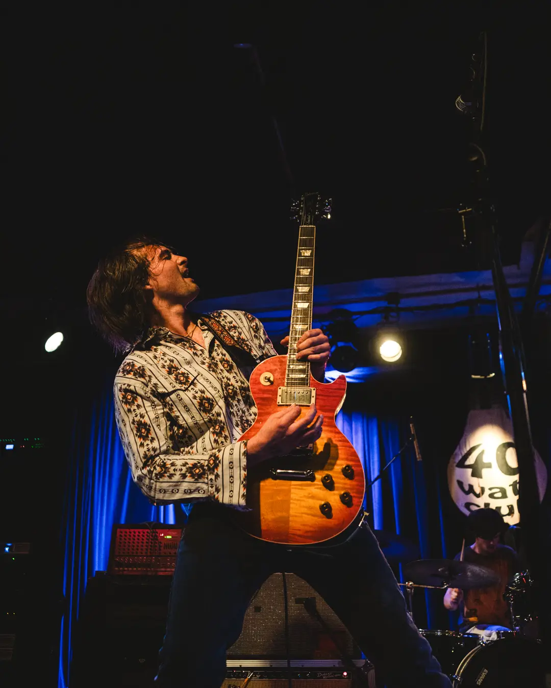 Lewis Ashe playing a Les Paul under blue light at the 40 Watt Club.
